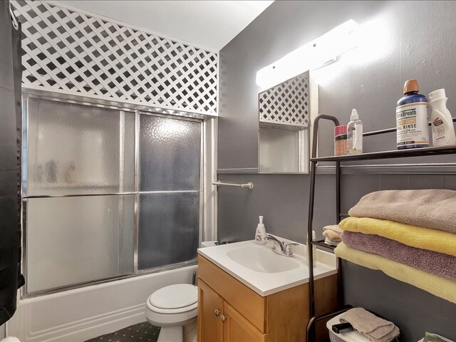 full bathroom with vanity, toilet, and enclosed tub / shower combo