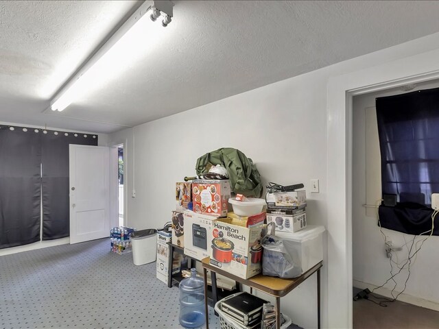 miscellaneous room with a textured ceiling