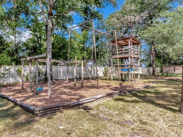 view of jungle gym with a lawn