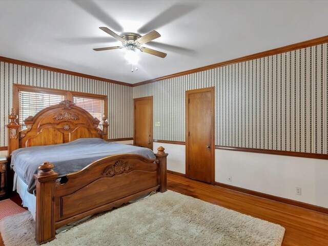 bedroom featuring ceiling fan, crown molding, and light wood-type flooring