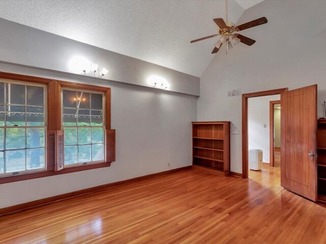 unfurnished room featuring ceiling fan, light wood-type flooring, and a textured ceiling