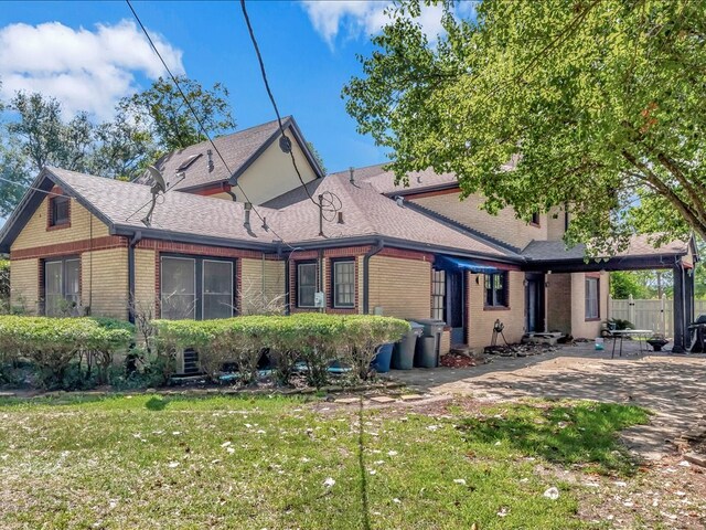 back of property featuring a lawn