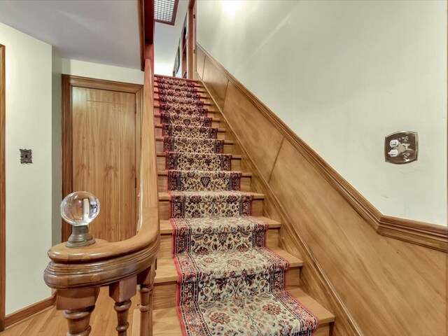 stairs featuring wood-type flooring