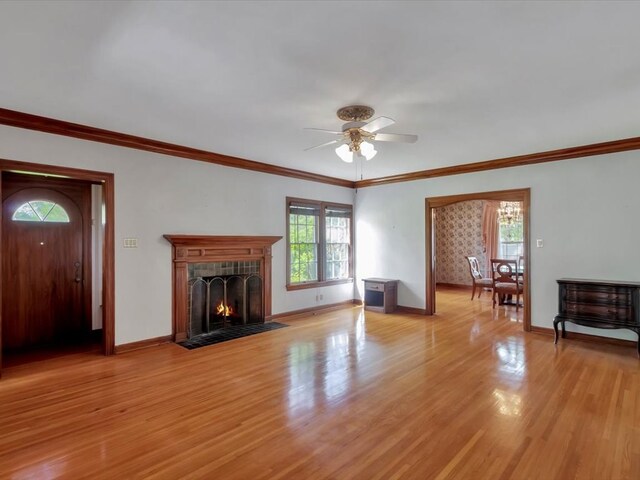 unfurnished living room featuring light hardwood / wood-style floors, ceiling fan, and crown molding