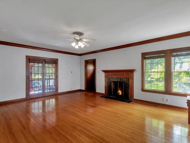 unfurnished living room with light hardwood / wood-style floors, a wealth of natural light, and ceiling fan