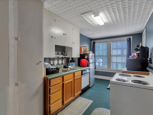 kitchen featuring dishwasher, white stove, and sink