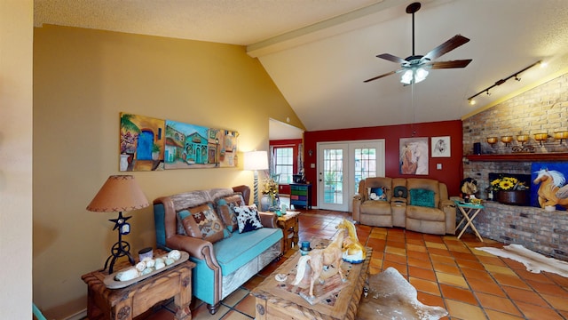 living room featuring ceiling fan, a fireplace, a textured ceiling, and french doors