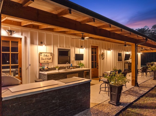 view of patio featuring wine cooler, ceiling fan, and sink