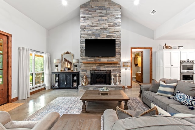 living room with a fireplace and high vaulted ceiling