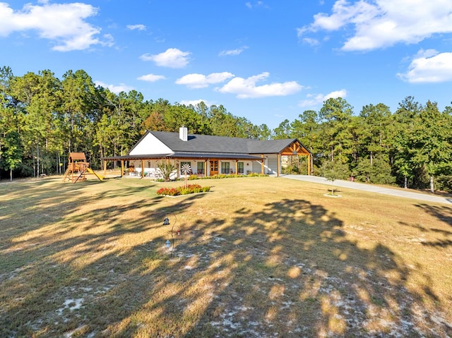 view of front of house featuring a front yard and a playground