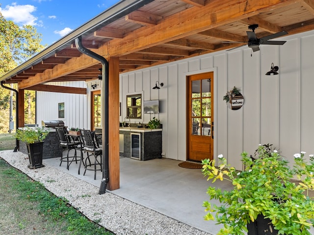 view of patio / terrace with wine cooler, ceiling fan, sink, and a grill