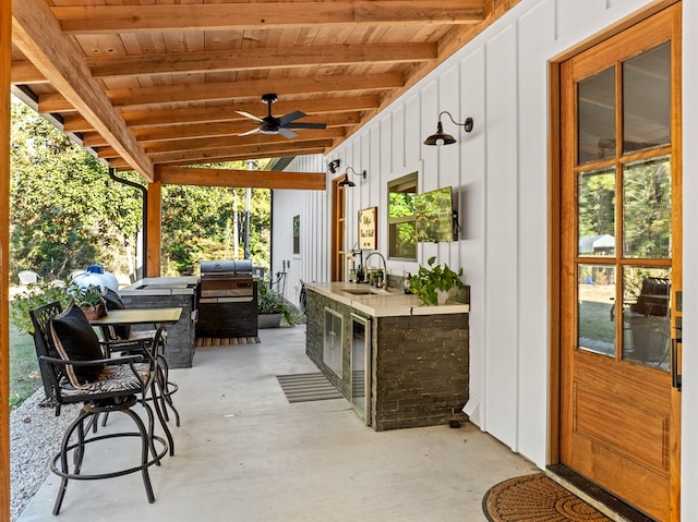 view of patio / terrace with ceiling fan, a grill, exterior kitchen, and sink