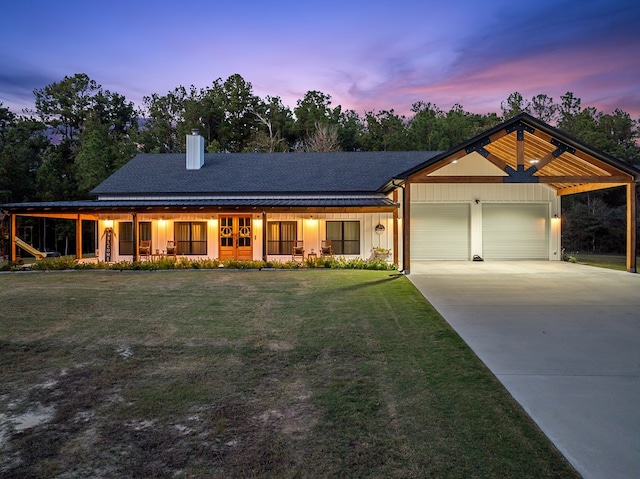 view of front facade with a lawn and a garage