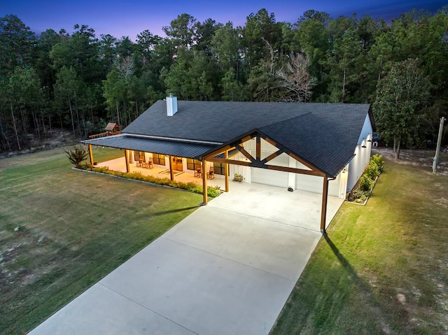 view of front of home featuring a garage and a yard