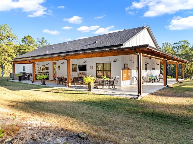 back of property featuring a patio and a lawn