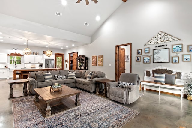 living room with high vaulted ceiling and ceiling fan