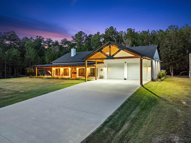 view of front of house with a garage and a yard