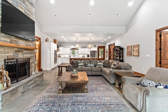 living room with concrete flooring and a fireplace