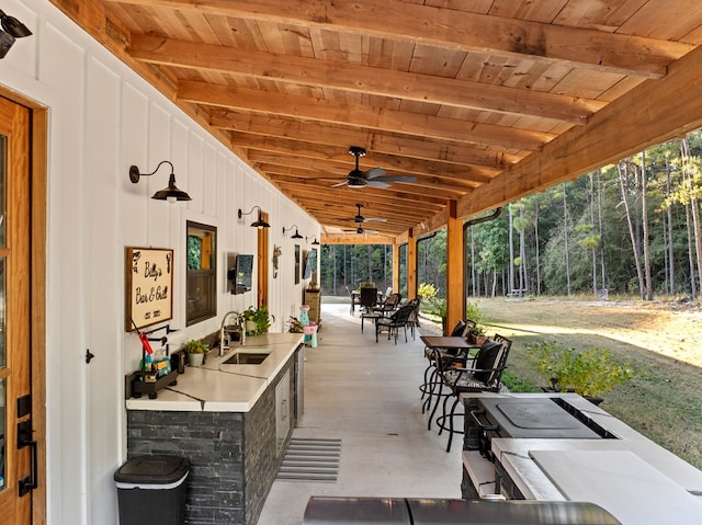 view of patio / terrace featuring ceiling fan and sink