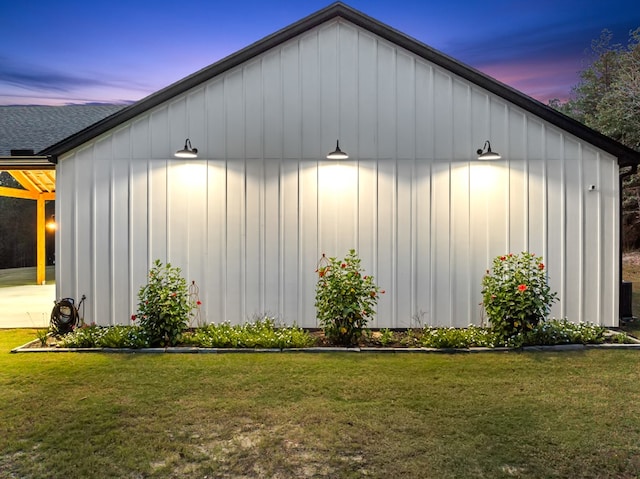 property exterior at dusk featuring a yard