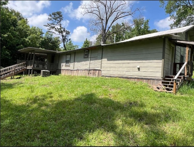 636 County Road 1165, Center, TX 75935 - back of house featuring central air condition unit, a yard, and stairs