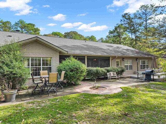 back of house with a yard and a patio