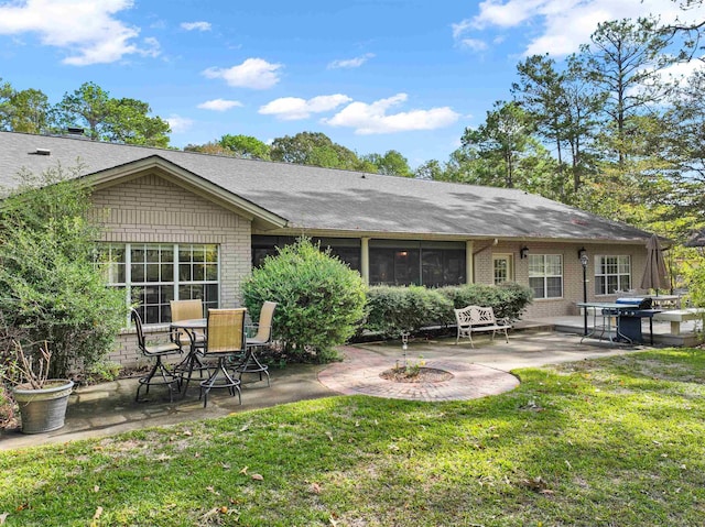 827 Duffer Dr, Brookeland, TX 75931 - rear view of property featuring a patio area, a yard, and brick siding