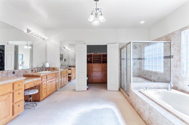 bathroom with shower with separate bathtub, vanity, and a notable chandelier