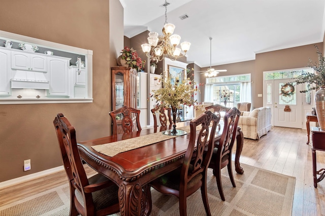 827 Duffer Dr, Brookeland, TX 75931 - dining space with a chandelier, light wood-style floors, and high vaulted ceiling