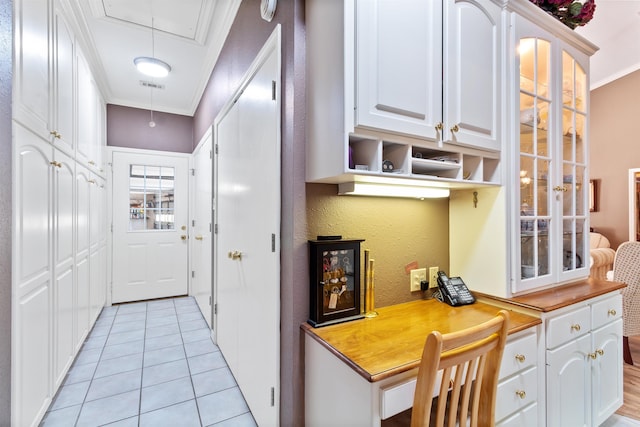 827 Duffer Dr, Brookeland, TX 75931 - kitchen with white cabinetry, ornamental molding, and light tile patterned floors