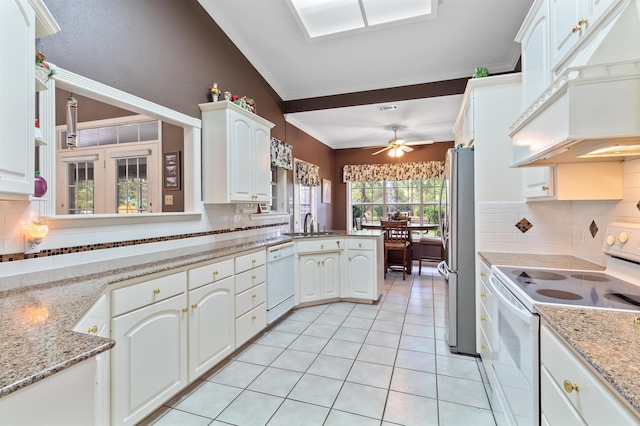 827 Duffer Dr, Brookeland, TX 75931 - kitchen with white appliances, custom exhaust hood, decorative backsplash, light tile patterned floors, and crown molding