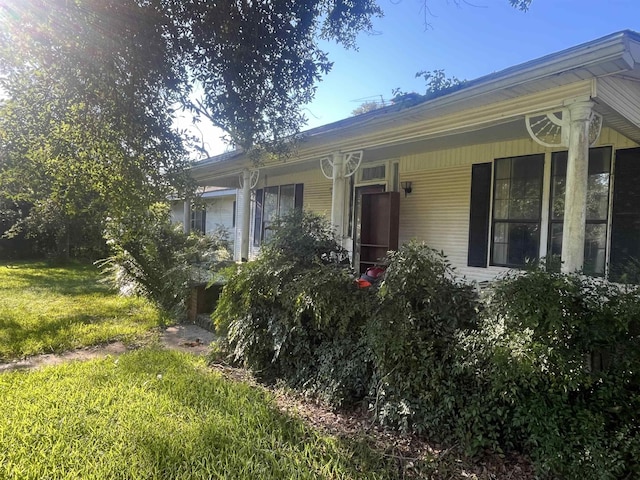 view of property exterior with a lawn