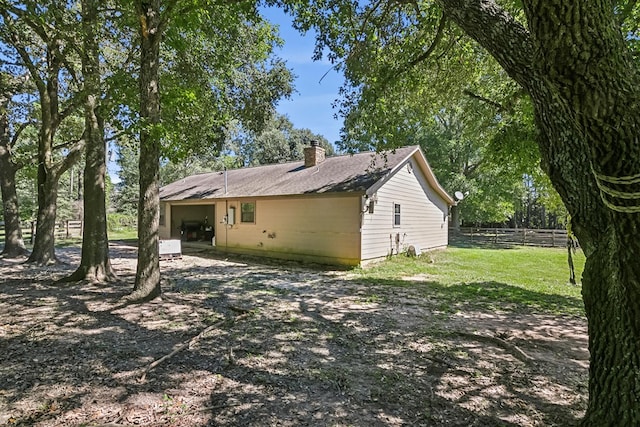 back of house featuring a yard