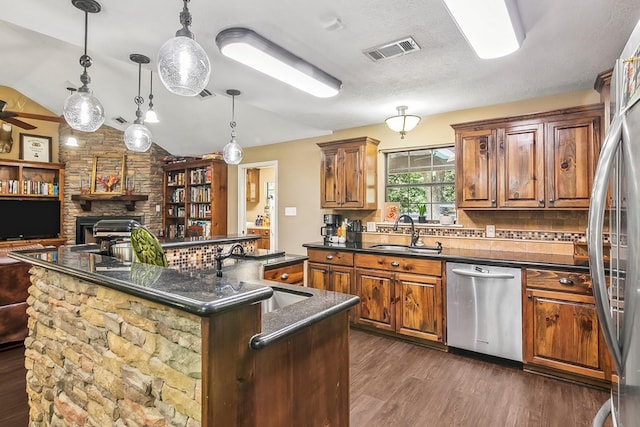 kitchen with vaulted ceiling, dark wood-type flooring, sink, dishwasher, and a center island