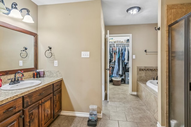 bathroom featuring tile patterned floors, vanity, and separate shower and tub