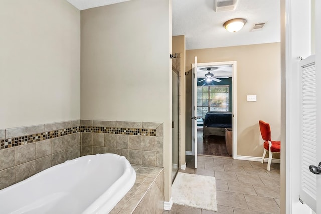 bathroom featuring tile patterned flooring, separate shower and tub, and a textured ceiling