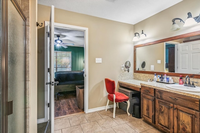 bathroom with tile patterned floors, ceiling fan, a textured ceiling, and vanity