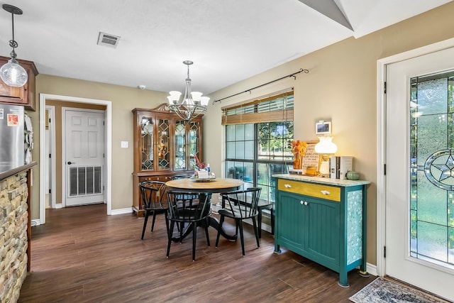 dining room featuring dark wood-type flooring and a chandelier