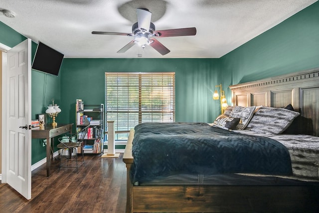 bedroom with ceiling fan, dark hardwood / wood-style flooring, and a textured ceiling