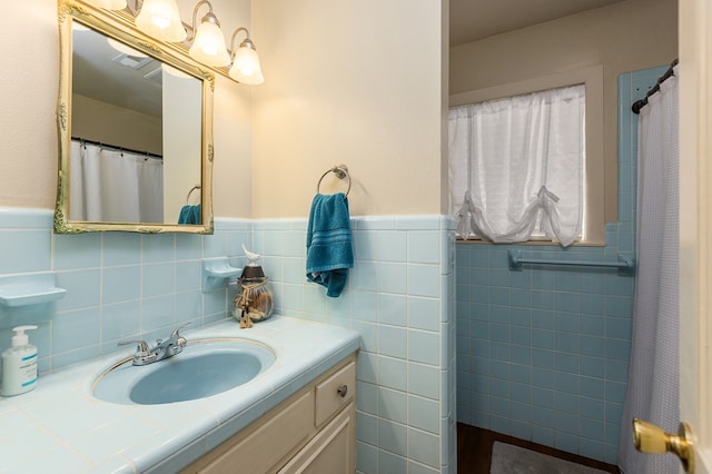 bathroom with vanity and tile walls