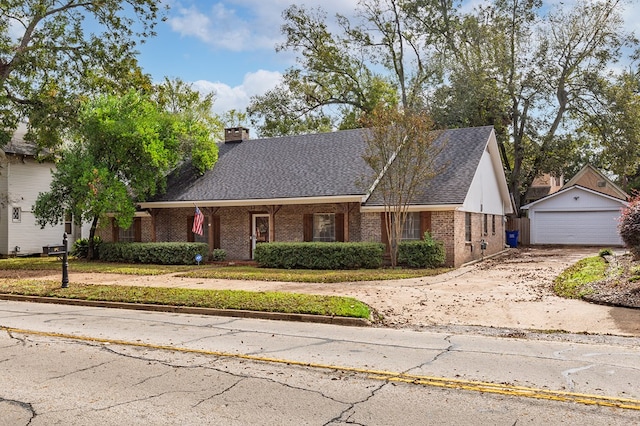 view of front of house featuring a garage and an outdoor structure