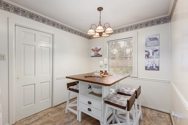 dining room featuring crown molding and an inviting chandelier