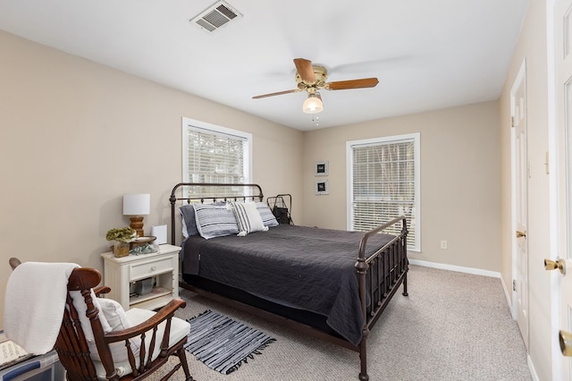 bedroom with ceiling fan and light carpet