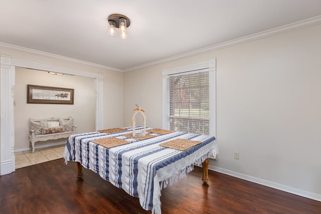 bedroom with hardwood / wood-style floors and crown molding