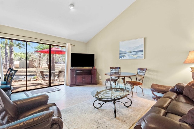 living room with light tile patterned flooring and high vaulted ceiling