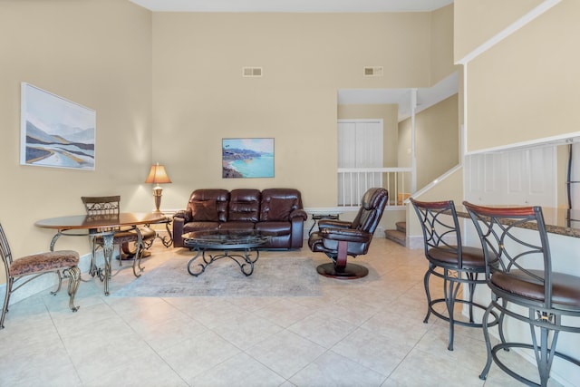 tiled living room with a high ceiling