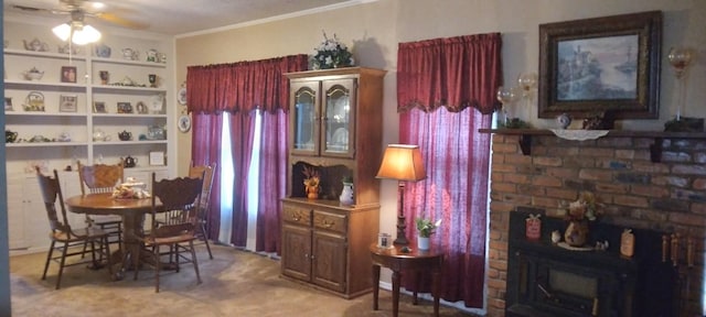 dining room with light colored carpet, ceiling fan, and ornamental molding