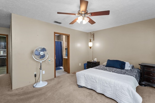 carpeted bedroom featuring ensuite bathroom, ceiling fan, and a textured ceiling