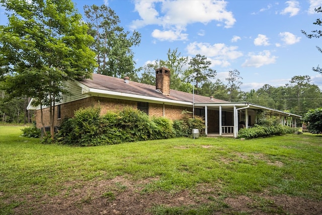 rear view of house with a lawn