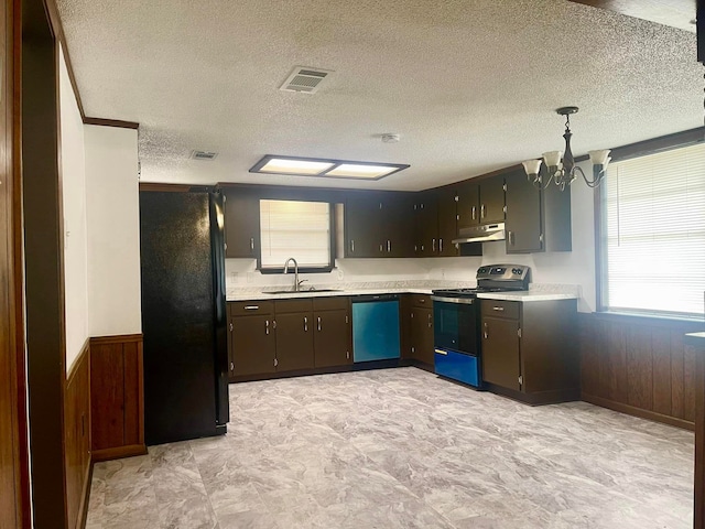 kitchen featuring sink, pendant lighting, a textured ceiling, and appliances with stainless steel finishes